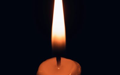 Candlelight in darkness symbolizing awareness as the first step.